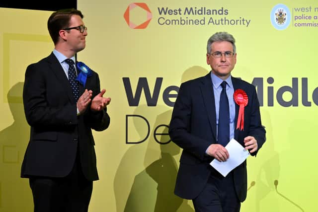 Conservative candidate Tom Byrne (L) applauds as Labour candidate Simon Foster wins the vote to become West Midlands Police and Crime Commissioner ahead of the declaration for West Midlands Mayor