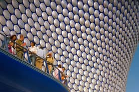 Members of the public admire the unique design of Selfridges, with the building opening just a year earlier