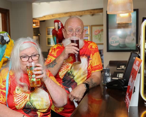 Spider, 66, and Anne Spider-McKeown, 64, from Birmingham, go about their daily routine with two parrots Charlie a green-winged Macaw and Chester