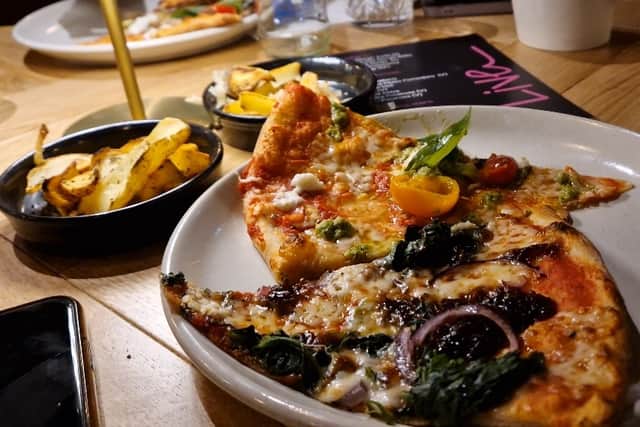 The menu offers a delightful array of starters, pizzas, and drinks