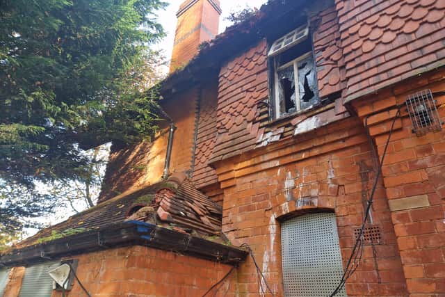 Windows are smashed and doors are boarded up