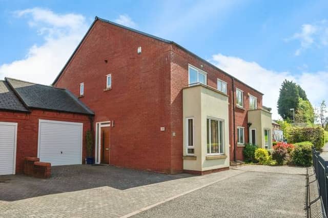A quiet cul-de-sac setting with driveway and garage parking makes this Birmingham family home instantly appealing
