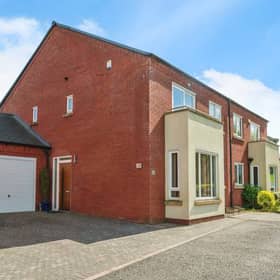 A quiet cul-de-sac setting with driveway and garage parking makes this Birmingham family home instantly appealing