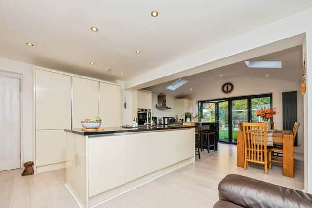 The extended kitchen is the heart of the home, complete with integrated appliances and bi-fold doors opening to the garden