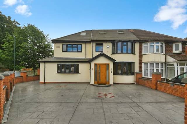 The front of the property with off-road parking for multiple vehicles, giving a clear sense of the home’s size and strong street presence