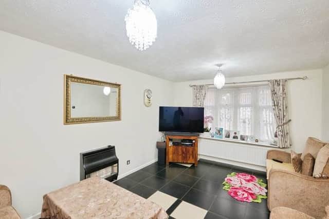 A bright and comfortable living room that flows naturally into the dining space, ideal for relaxing or hosting guests