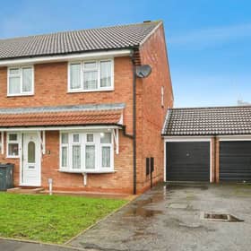 A smart semi-detached frontage with driveway parking, setting the tone for a practical and well-sized family home