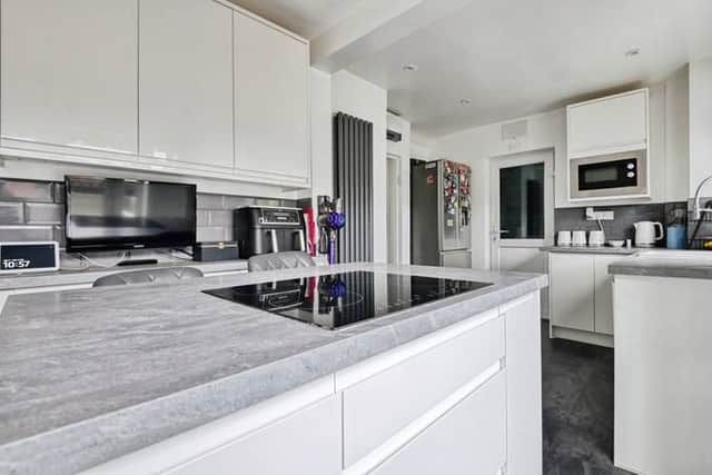 The fitted kitchen offers practical storage and worktop space, with easy access through to the rear garden