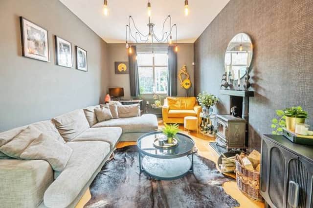 A bright dual-aspect living room with a characterful log burner, creating a warm and inviting heart to the home