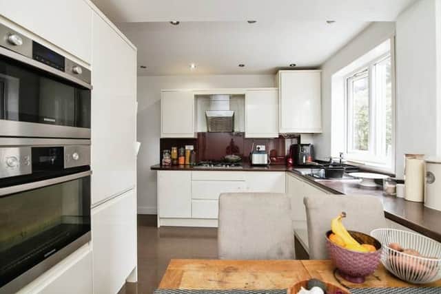 The spacious kitchen and breakfast area forms the practical heart of the home, with plenty of storage and room for busy family life