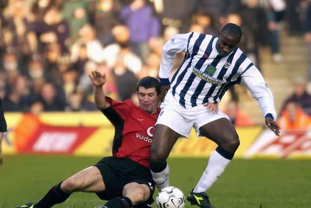 Jason Roberts shields the ball from Manchester United’s Roy Keane.
