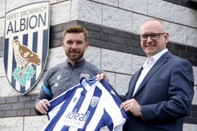 WALSALL, ENGLAND - MAY 1: West Bromwich Albion new Head Coach James Morrison holds a shirt in-front of a club crest / badge with Executive Director Mark Miles at West Bromwich Albion Training Ground on May 1, 2026 in Walsall, England.  (Photo by Adam Fradgley/West Bromwich Albion FC via Getty Images)