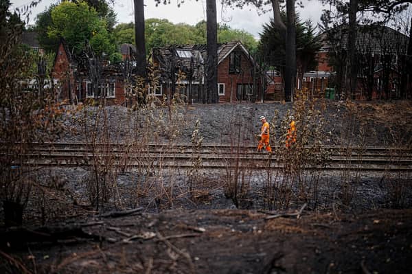 Network rail workers inspect the track and embankment after the Stourbridge wildfire 