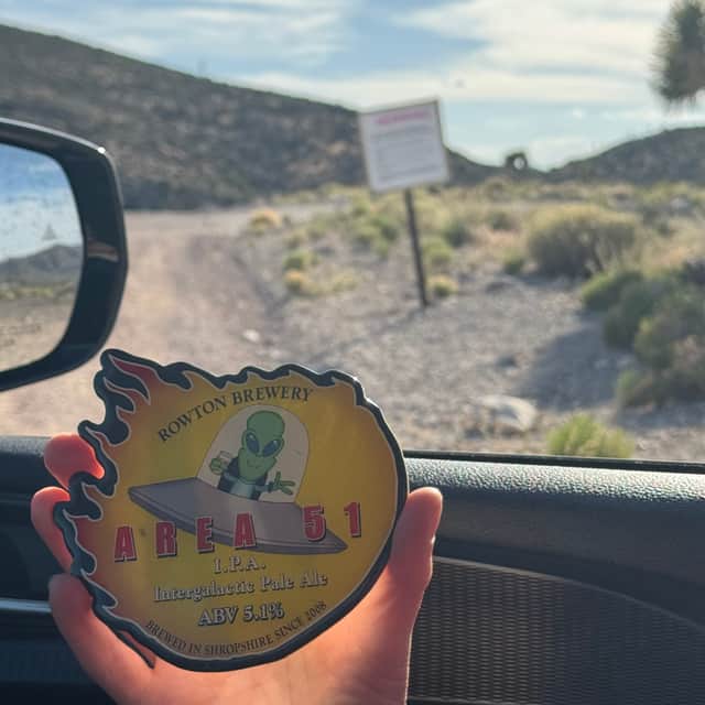 Phil on the perimeter of the air force base with the Rowton beer mat