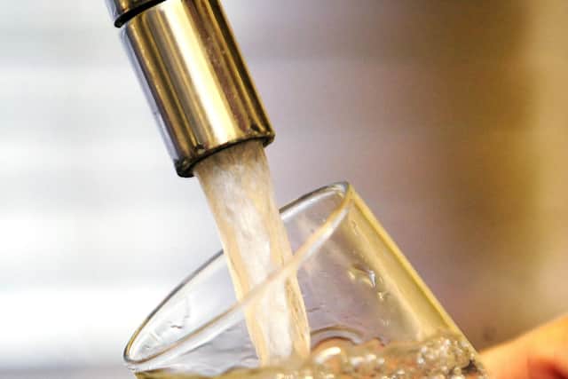 Water pouring into a tap