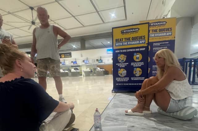 Nathan Elliot and his family sit at Lanzarote Airport where they are stuck following tech outages as UK flights cancelled