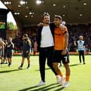 Wolves boss Cesar Peixoto (left) embraces midfielder Andre after victory in the Black Country derby