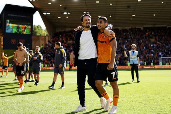 Wolves boss Cesar Peixoto (left) embraces midfielder Andre after victory in the Black Country derby