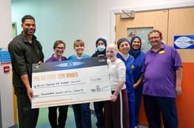 Joleon Lescott (far left) presenting £11,500 donation cheque, with patient Elizabeth Soffe (centre right, front) and Burns Centre clinical staff