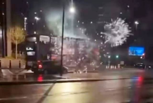 A bus in Birmingham, under attack from somebody shooting fireworks at it.