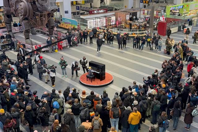 A crowd gathers to watch Bowen playing Take Five during filming of The Piano