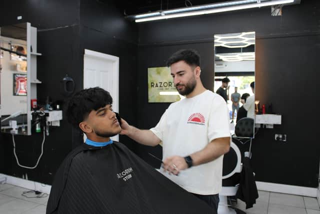 Razwan workign on Esa's new hair cut