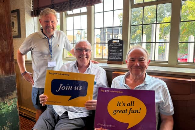 Wayne (Oddfellows Social Organiser for Birmingham) standing next to a seated Michael Phipps and Robert, another member of the Oddfellows)