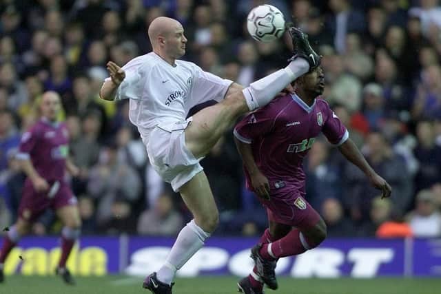 Danny Mills hits the ball past Aston Villa's Darius Vassell during the Premiership clash at Elland Road in November 2001.