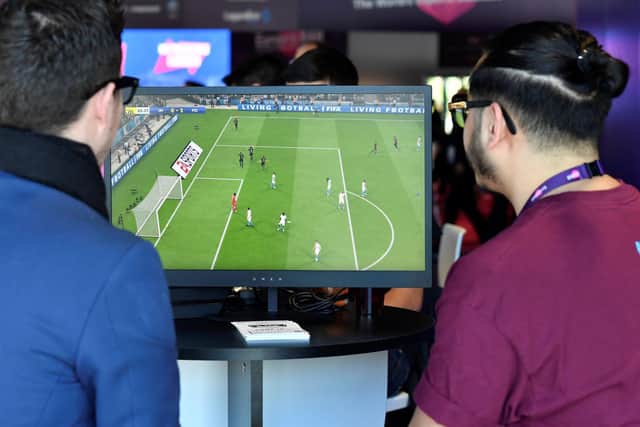 Visitors playing the FIFA computer game at the eSports Bar trade fair in Cannes, southern France. Photo: Getty Images