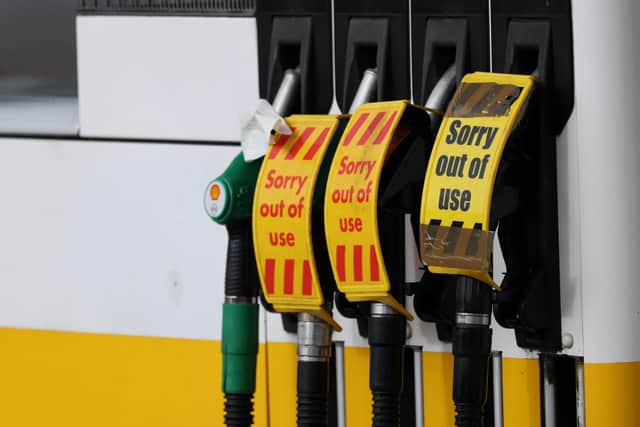 'Out of Use' signage is pictured on the petrol pumps  of a closed fuel filling station.  (Photo by ADRIAN DENNIS/AFP via Getty Images)
