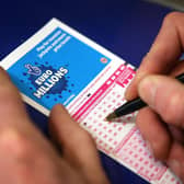 Filling out a National Lottery ticket.  (Photo by Peter Macdiarmid/Getty Images)