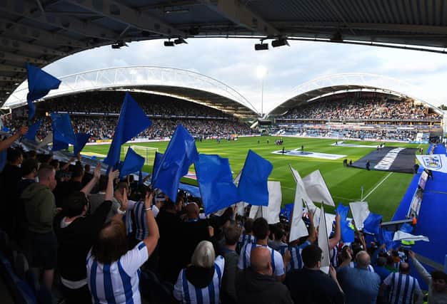 HUDDERSFIELD, ENGLAND - AUGUST 05: Huddersfield Town fans wave flags prior to the Sky Bet Championship match between Huddersfield Town and Derby County at John Smith's Stadium on August 05, 2019 in Huddersfield, England. (Photo by George Wood/Getty Images)