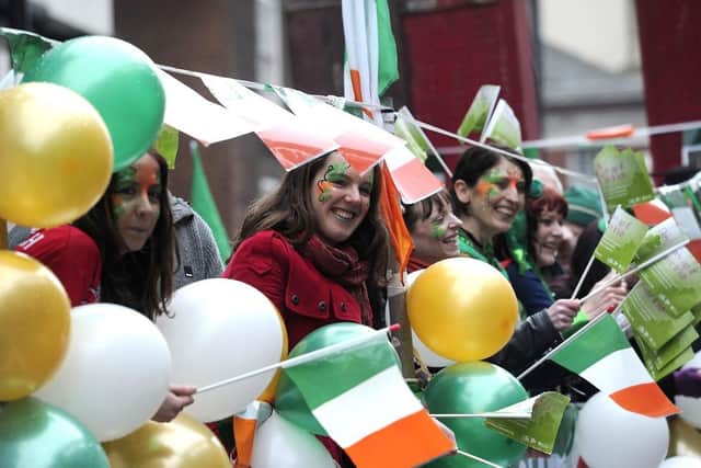 People bearing the colours of Ireland and smile during the St Patrick's Day parade. (Pic credit: Carl Court / AFP via Getty Images)
