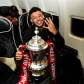 Alex Oxlade-Chamberlain, football player for Liverpool FCLONDON, ENGLAND - MAY 14: (THE SUN OUT, THE SUN ON SUNDAY OUT) l1 with the Emirates FA Cup trophy on board a flight back to Liverpool after winning the  The Emirates FA Cup Final match between Chelsea and Liverpool at Wembley Stadium on May 14, 2022 in London, England. (Photo by Andrew Powell/Liverpool FC via Getty Images)