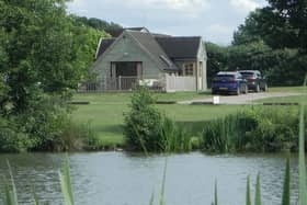 The Skylark Lodge at Brook Meadow viewed from across the campsite's five-acre fishing lake
