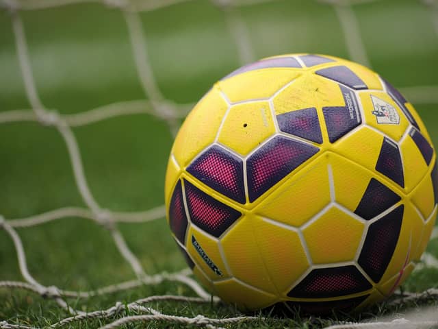 File photo dated 28/2/2015 of a ball in the net. Premier League football clubs are being urged to end "poverty pay" among staff including cleaners and security guards amid record player signings ahead of the new season.