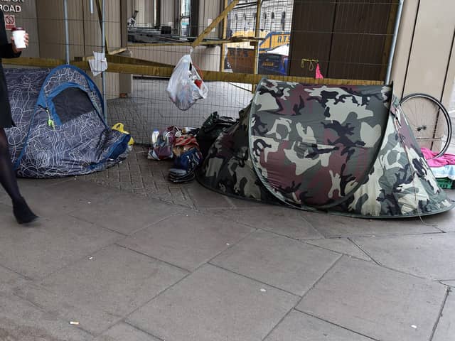 A woman walks past tents of the homeless in Victoria, London. PA Photo. Picture date: Thursday January 16, 2020. Photo credit should read: Nick Ansell/PA Wire