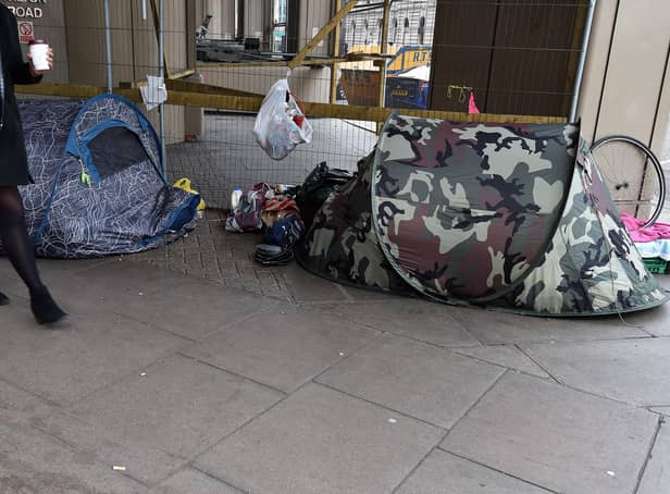 A woman walks past tents of the homeless in Victoria, London. PA Photo. Picture date: Thursday January 16, 2020. Photo credit should read: Nick Ansell/PA Wire
