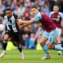 Callum Wilson of Newcastle United battles for possession with James Tarkowski of Burnley during the Premier League match between Burnley and Newcastle United at Turf Moor on May 22, 2022 in Burnley, England. (Photo by Gareth Copley/Getty Images)