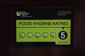 A 5/5 Food Standards Agency rating sticker on a window of a restaurant