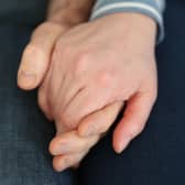 File photo dated 05/02/20 of a married couple holding hands, as couples could receive financial support from their partners if relationships break down, a report aimed at reforming the law for cohabiters in Scotland has suggested.