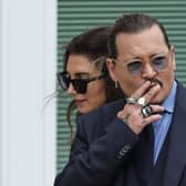 FAIRFAX, VIRGINIA - MAY 27: Actor Johnny Depp smokes during a break in his trial at a Fairfax County Courthouse on May 27, 2022 in Fairfax, Virginia. Closing arguments in the Depp v. Heard defamation trial, brought by Johnny Depp against his ex-wife Amber Heard, begins today. (Photo by Kevin Dietsch/Getty Images)