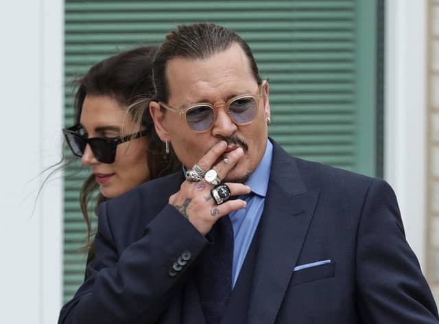 FAIRFAX, VIRGINIA - MAY 27: Actor Johnny Depp smokes during a break in his trial at a Fairfax County Courthouse on May 27, 2022 in Fairfax, Virginia. Closing arguments in the Depp v. Heard defamation trial, brought by Johnny Depp against his ex-wife Amber Heard, begins today. (Photo by Kevin Dietsch/Getty Images)