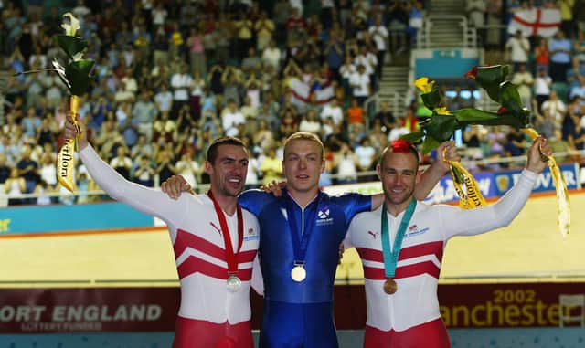 Jason Queally of England (Silver) Chris Hoy of Scotland (Gold) and Jamie Staff of England (Bronze) after the Men's 1000m time trail final at the National Cycling centre during the 2002 Commonwealth Games in Manchester, England on July 28, 2002. (Photo by Laurence Griffiths/Getty Images)