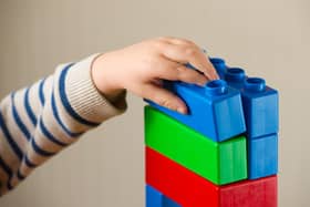 File photo dated 24/01/16 of a preschool age child playing with plastic building blocks, as outsourcing children's care placements to private providers is associated with worse outcomes for young people, a study has suggested.