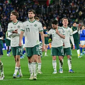 Dejected Northern Ireland players after their World Cup play-off semi-final defeat to Italy. (Photo by Stefano RELLANDINI / AFP via Getty Images)