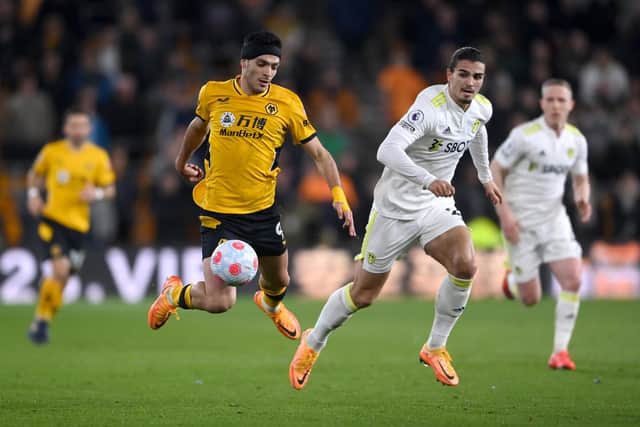 WOLVERHAMPTON, ENGLAND - MARCH 18: Raul Jimenez of Wolverhampton Wanderers is fouled by Pascal Struijk of Leeds United during the Premier League match between Wolverhampton Wanderers and Leeds United at Molineux on March 18, 2022 in Wolverhampton, England. (Photo by Laurence Griffiths/Getty Images)