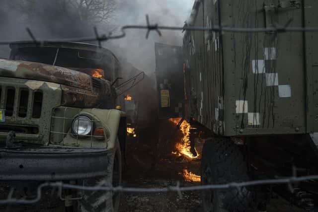 Ukrainian military track burns at an air defence base in the aftermath of an apparent Russian strike in Mariupol, Ukraine, Thursday, Feb. 24, 2022. Russian troops have launched their anticipated attack on Ukraine. Big explosions were heard before dawn in Kyiv, Kharkiv and Odesa as world leaders decried the start of Russian invasion that could cause massive casualties and topple Ukraine's democratically elected government. (AP Photo/Evgeniy Maloletka)