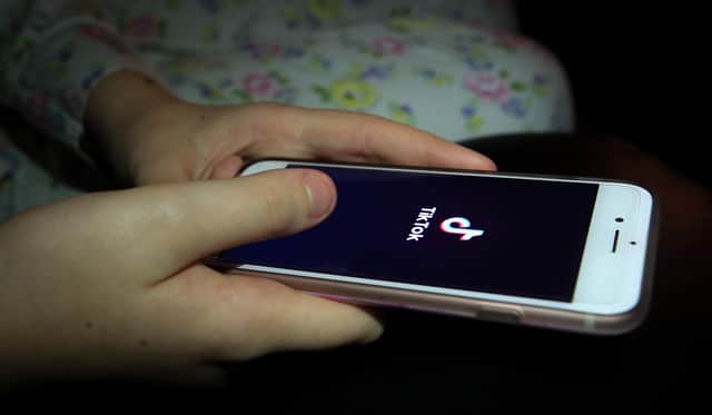 File photo dated 12/11/19 of a young person using the TikTok app on a smartphone, as some young TikTok users are being shown potentially dangerous content which could encourage eating disorders, self-harm and suicide, an online safety group has claimed.