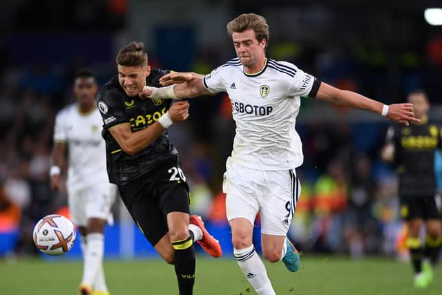 LEEDS, ENGLAND - OCTOBER 02: Patrick Bamford of Leeds United attempts to break the tackle of Jan Bednarek of Aston Villa during the Premier League match between Leeds United and Aston Villa at Elland Road on October 02, 2022 in Leeds, England. (Photo by Stu Forster/Getty Images)